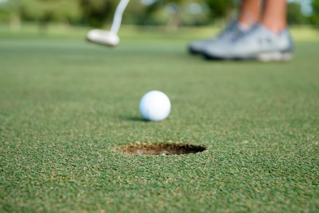Photo of golf ball near hole on the green.  A complete guide to beginners golf in Gold Beach.